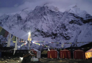 The puja chorten with a lamp on, and Annapurna behind wrapped in clouds.