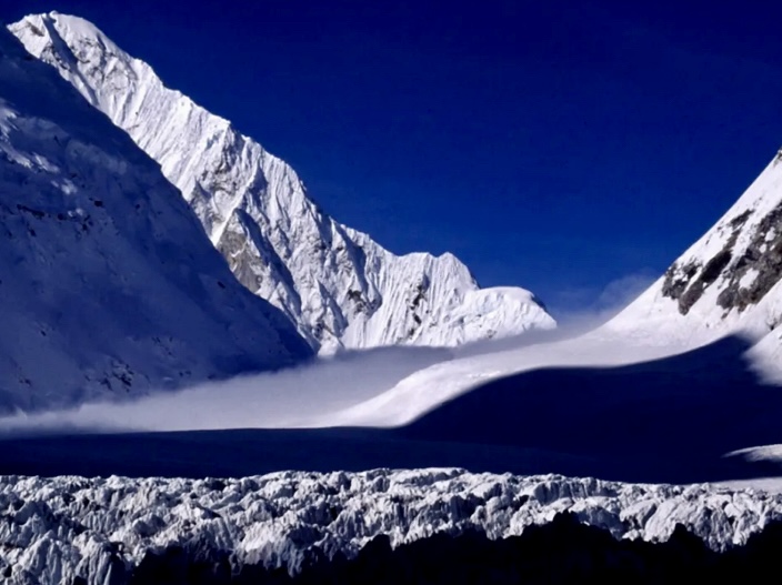 The Lho La under the morning fog, start of the West Ridge Direct in shadow on the far left. 