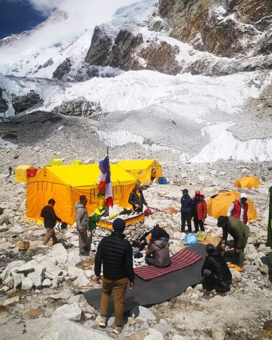 Climbers celebrating puja ceremony at the rocky base camp of Makalu.
