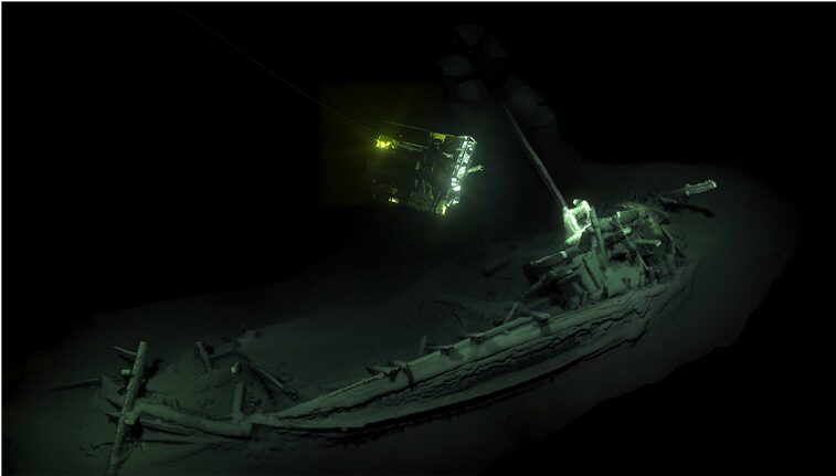 A shipwreck deep underwater, lit by a ROV