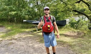 Kyle beside canoe