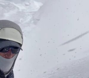 Climber moves his head away from a cloud of powder snow liberated by an avalanche on Annapurna.