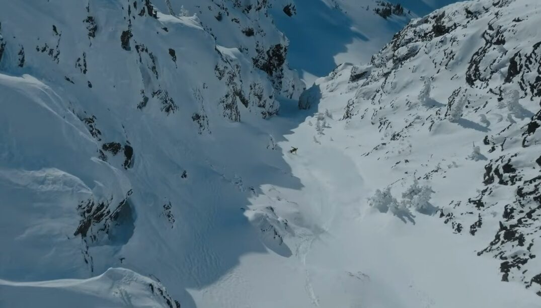 Joe snowboarding down a snowy slope.