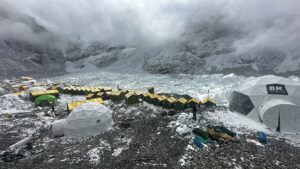 Tents in line on the Khumbu Glacier of Everest in a cloudy day.