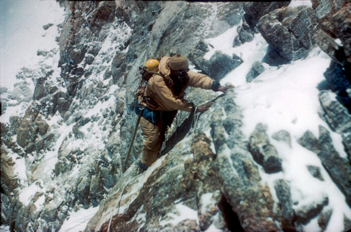 A climber on O2 in 1950's gear on mixed ground.