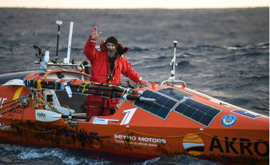 ocean rower in his orange boat