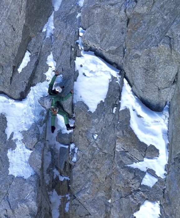 Climber on a vertical section of mixed terrain, North face of Grandes Jorasses.