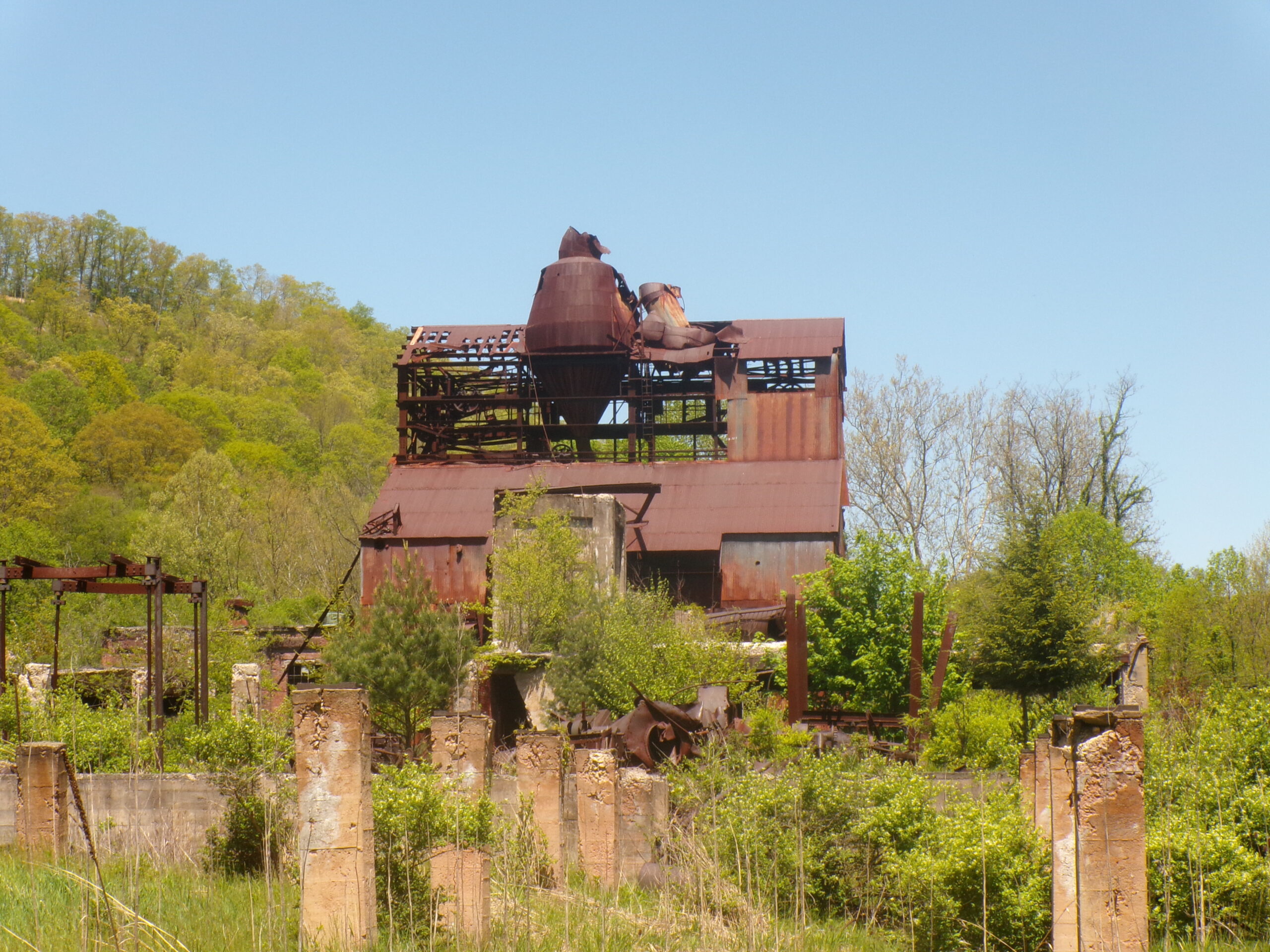 An abandoned mill surrounded by cinderblocks.