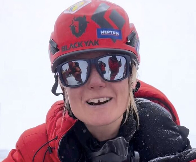 portrait of climber in a red helmet