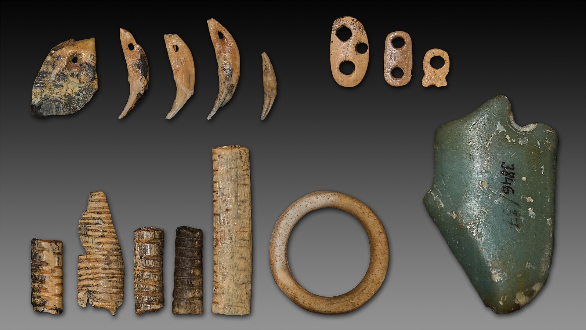 A selection of carved bone pendants, rings and other decorative items