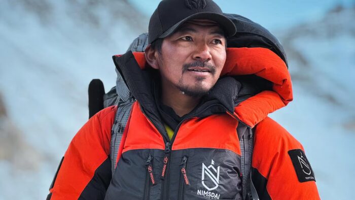 Close shot of Mingma David Sherpa with basebal cap and high-altitude down suit. 