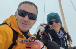 Denis Urubko and Maria Cardell inside a tent with sunglasses on.