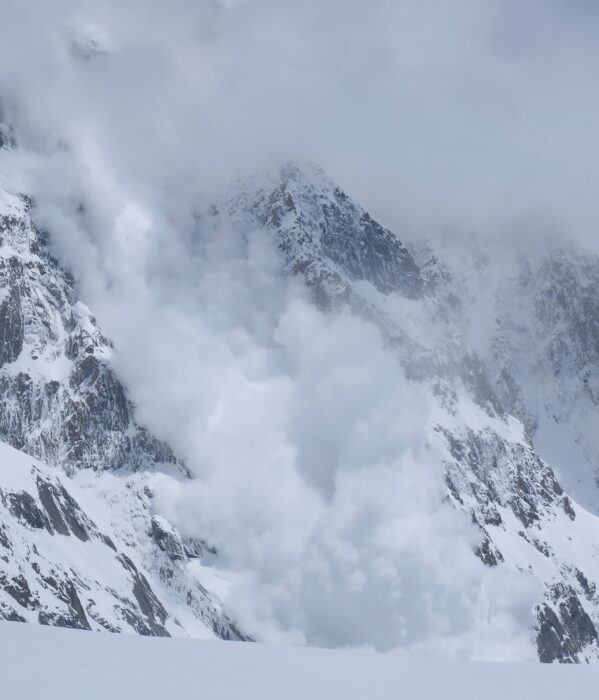 An avalanche covering a mountain face. 