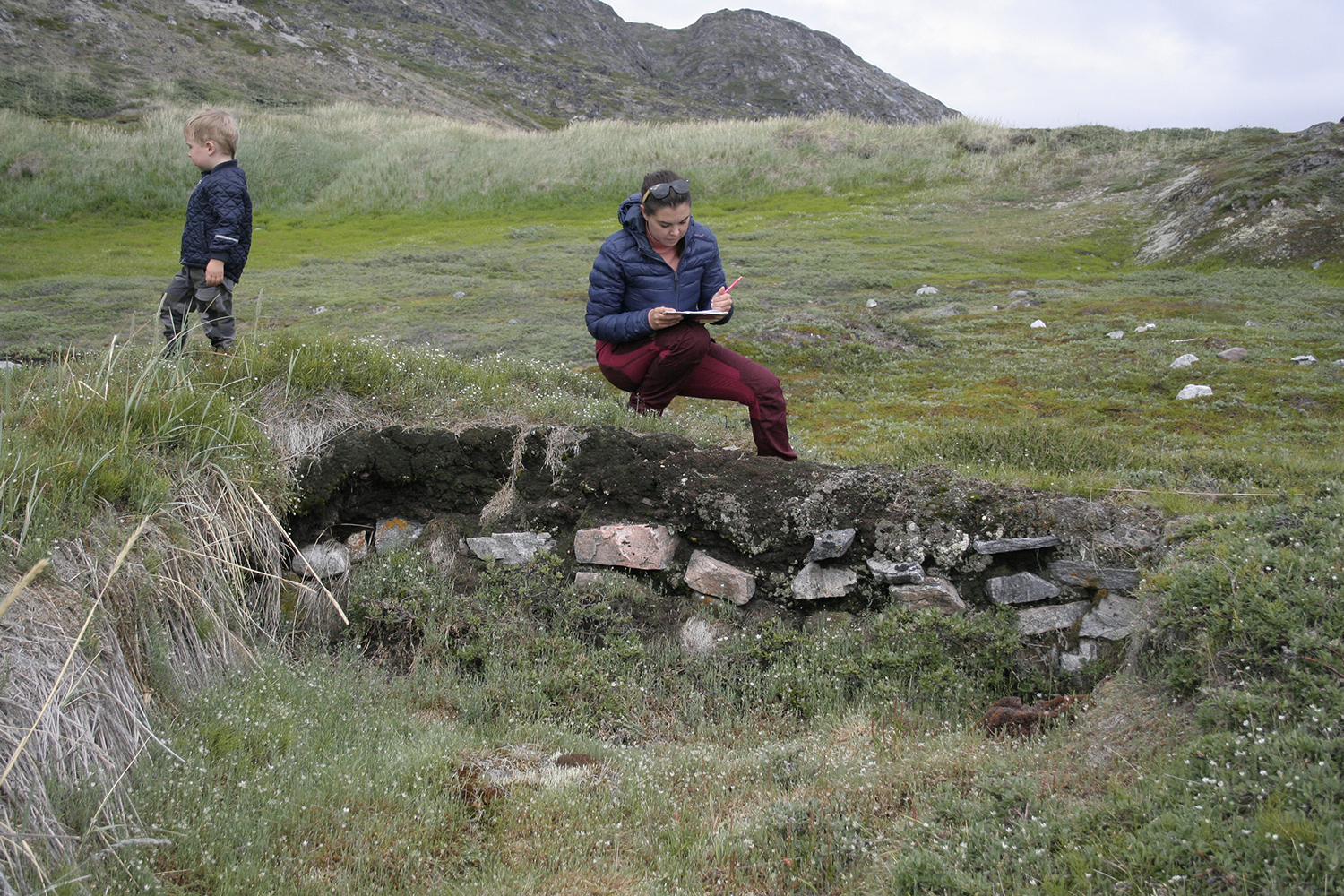 An archaeologist investigates a ruin.