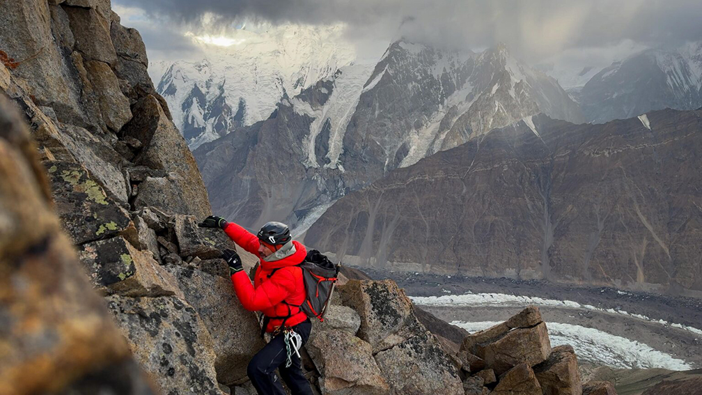 Woerle scrambling on rock to reach a ridge.