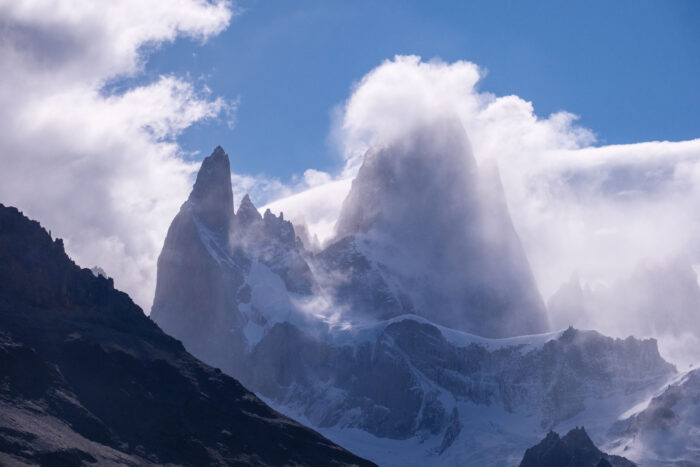 Fitz Roy massif wrapped in clouds and backlight.