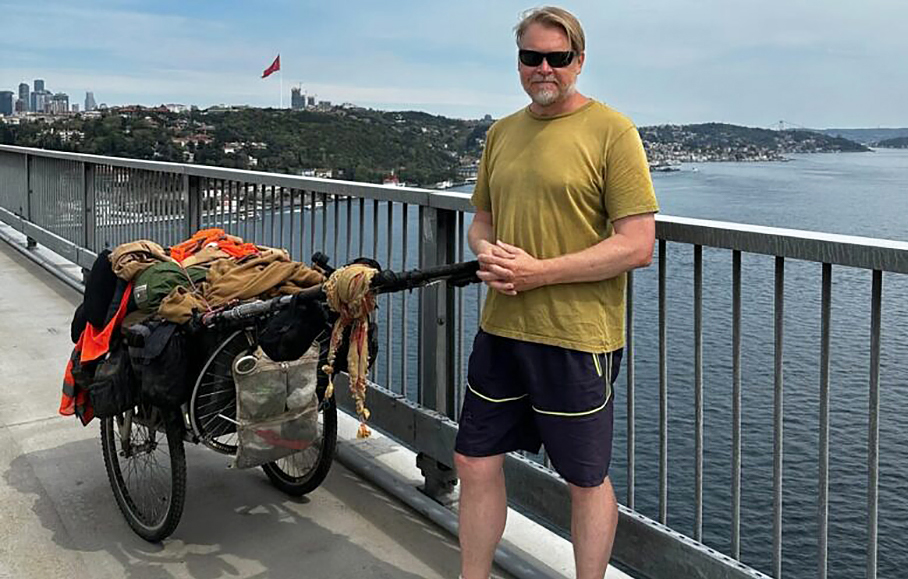 Karl Bushby beside a cart with supplies