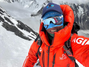 portrait of sherpa in red parka