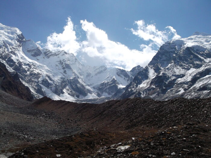 A large moutain rising at the far end of a flat valley.