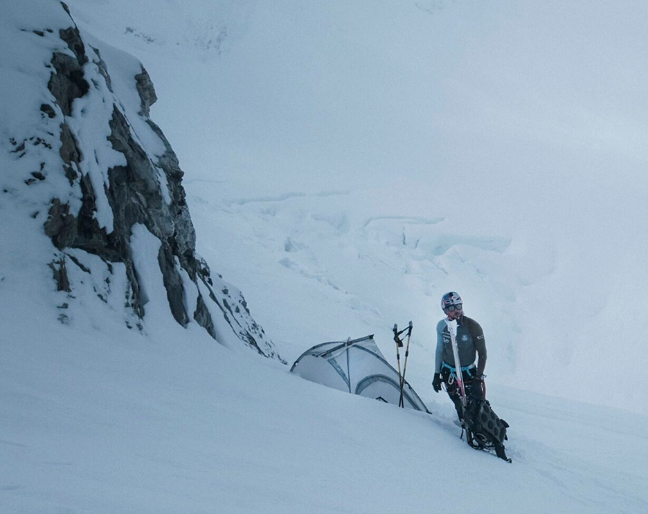 Bargiel in a foggy day, by a small tent planted in fresh snow.