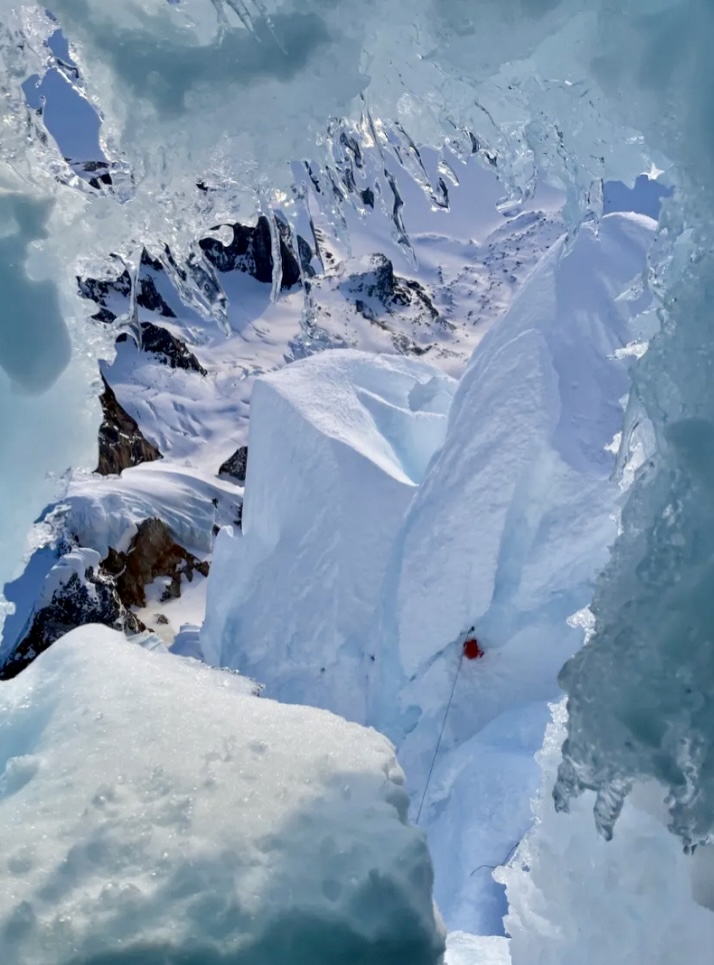 Colin Haley looking dwn towards his pack and belay, at the entrance of the false tunnel.
