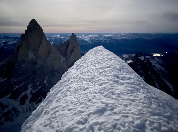 The summit of Cerro Torre, illuminated by moonlight.