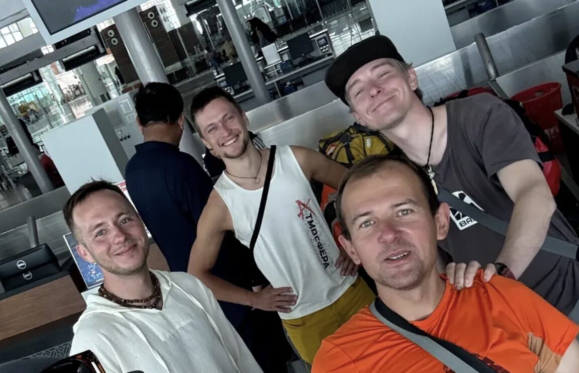 Russian climbers in t-shirts in an airport lounge.