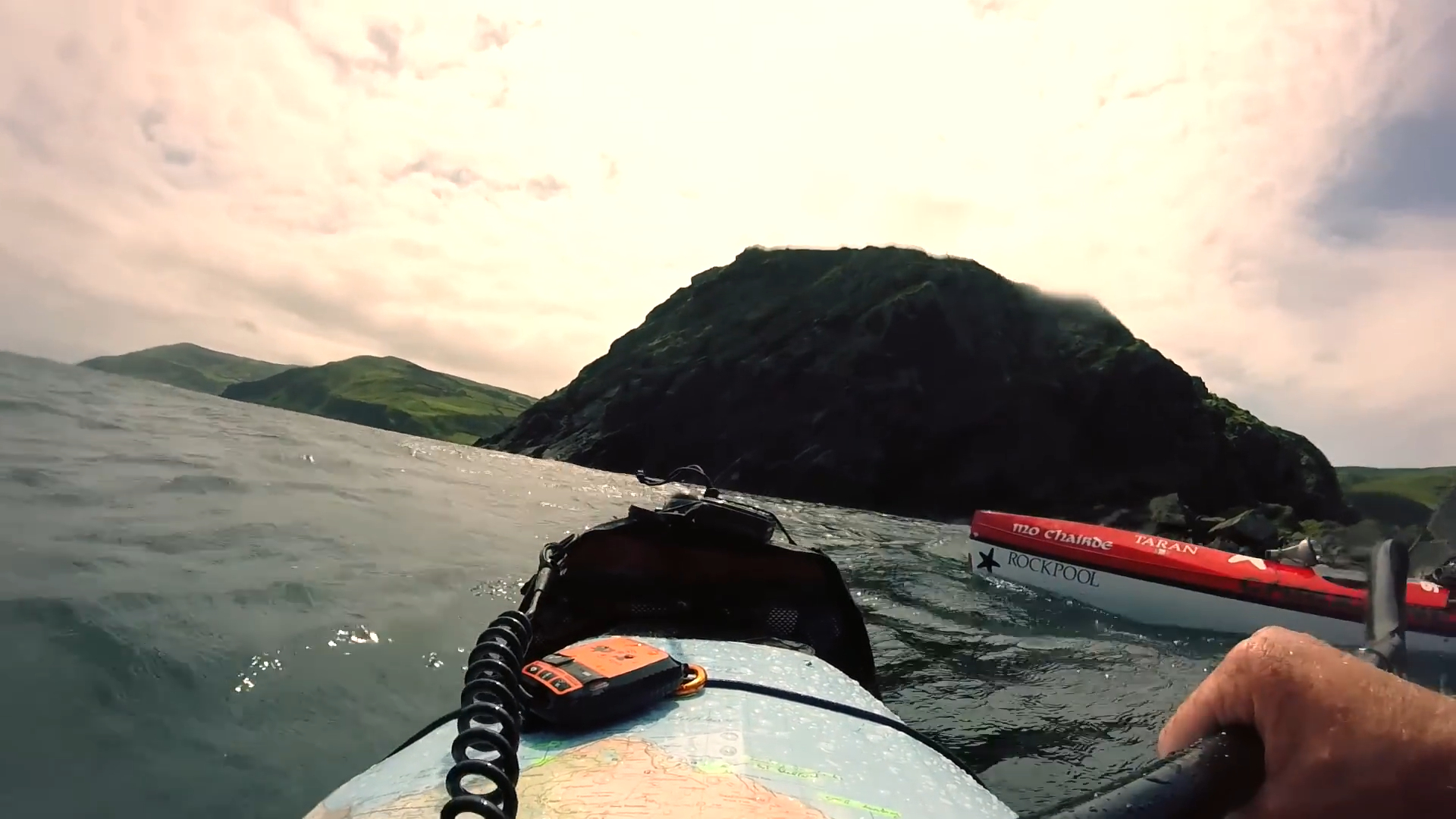 Kayaking by a green headland