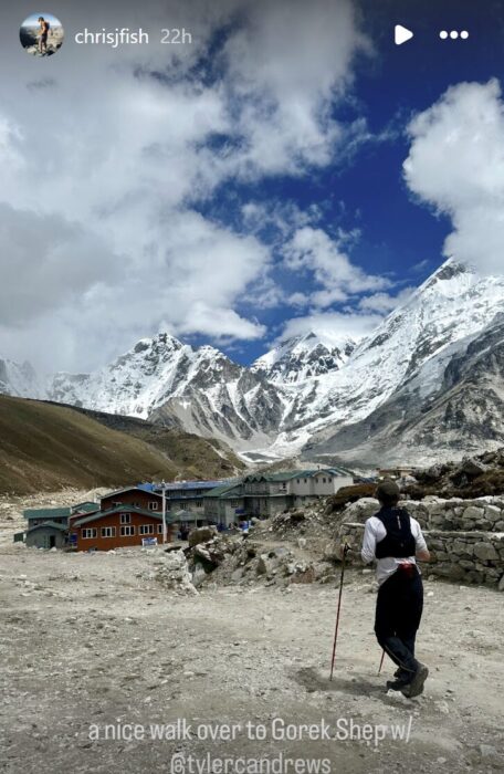 Tyler Andrews running on a dirt trail in the Khumbu, with mountains in front of him.