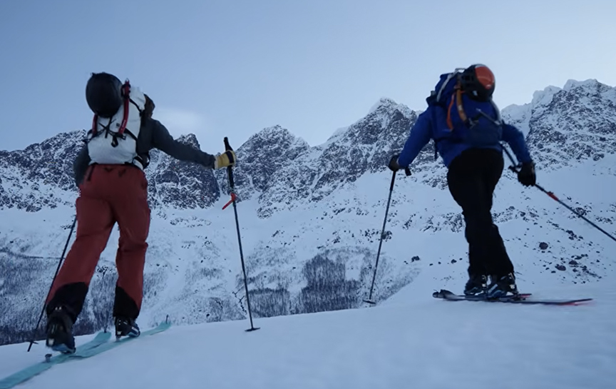two skiers skiing into the picture