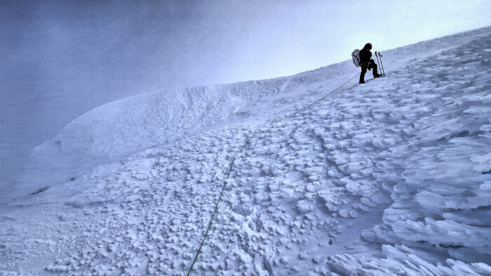 A climber on the hard snow of Lautaro Volcano.