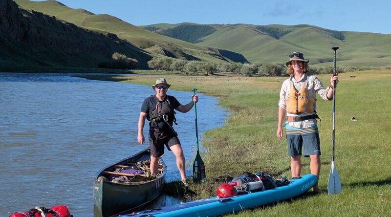 Matt Phillips and Phil Collins with canoes
