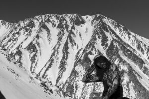 rapper in front of a mountain; black and white photo