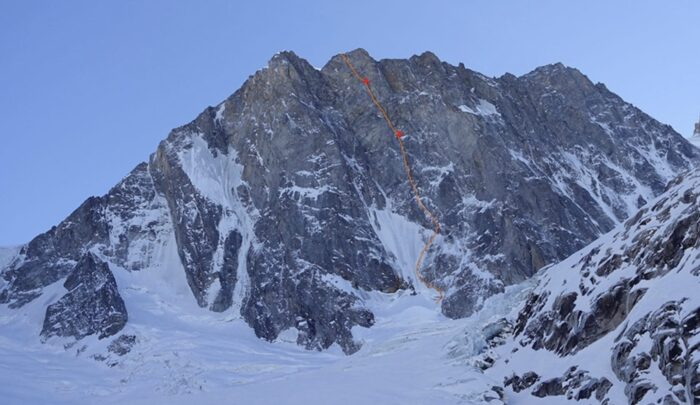 A route marked in read on a photo of the North face of the Grandes Jorasses, Mont Blanc Massif