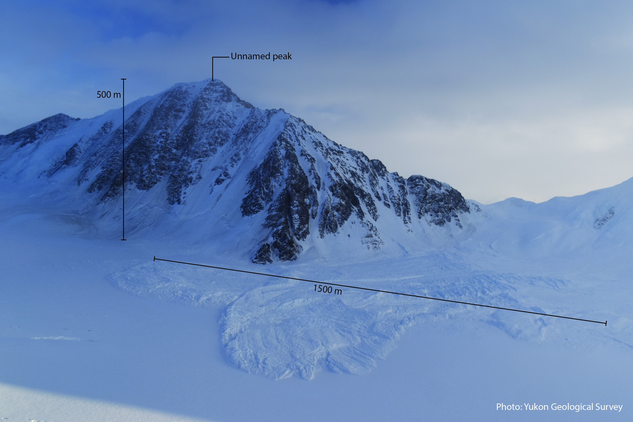 A short mountain with an obvious snow avalanche beneath it.