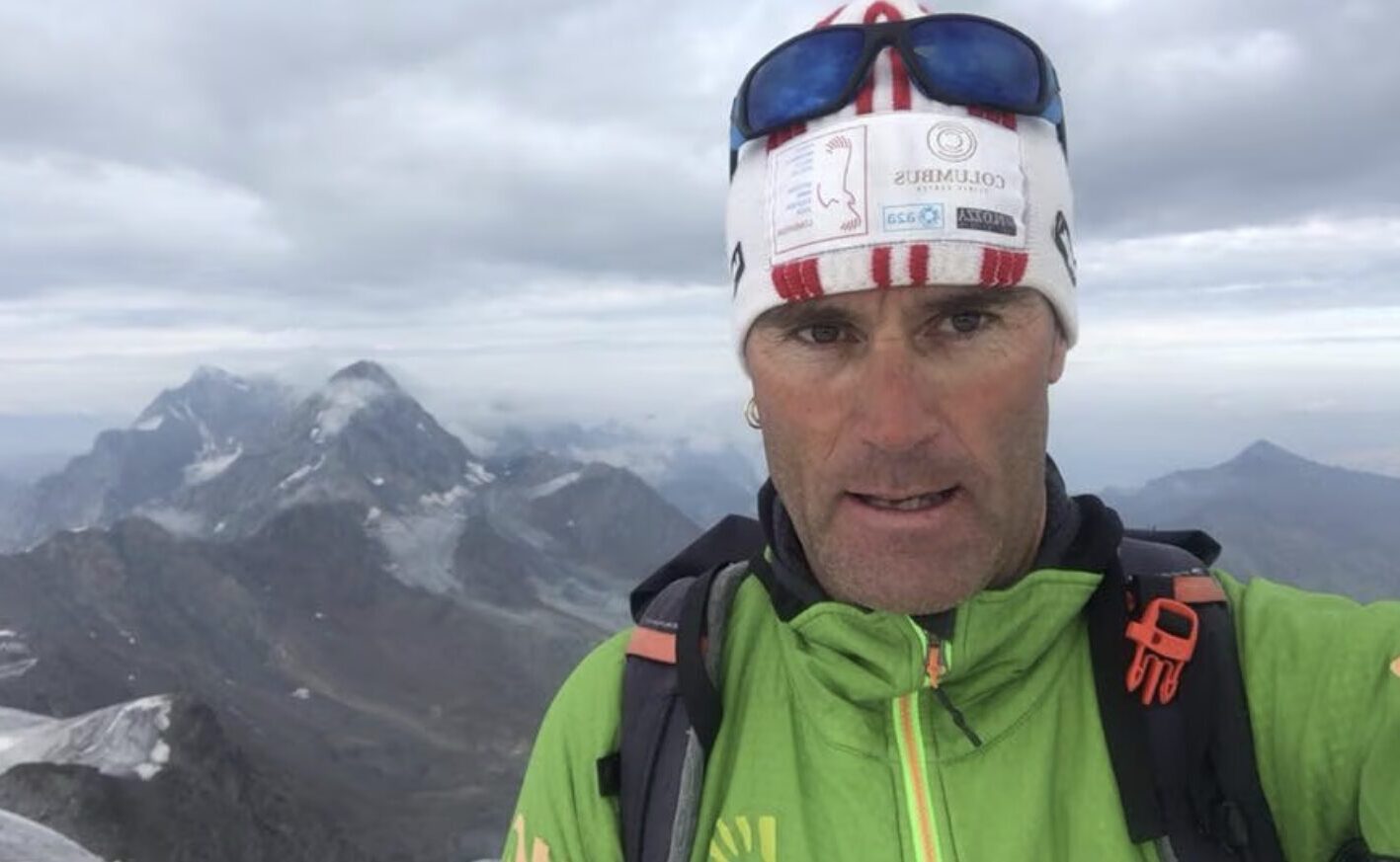Selfie by Marco Confortola with Italian Alps mountains in background.