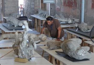 man examining plaster casts
