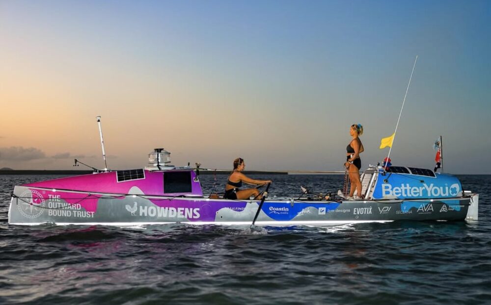 two women in an ocean rowboat