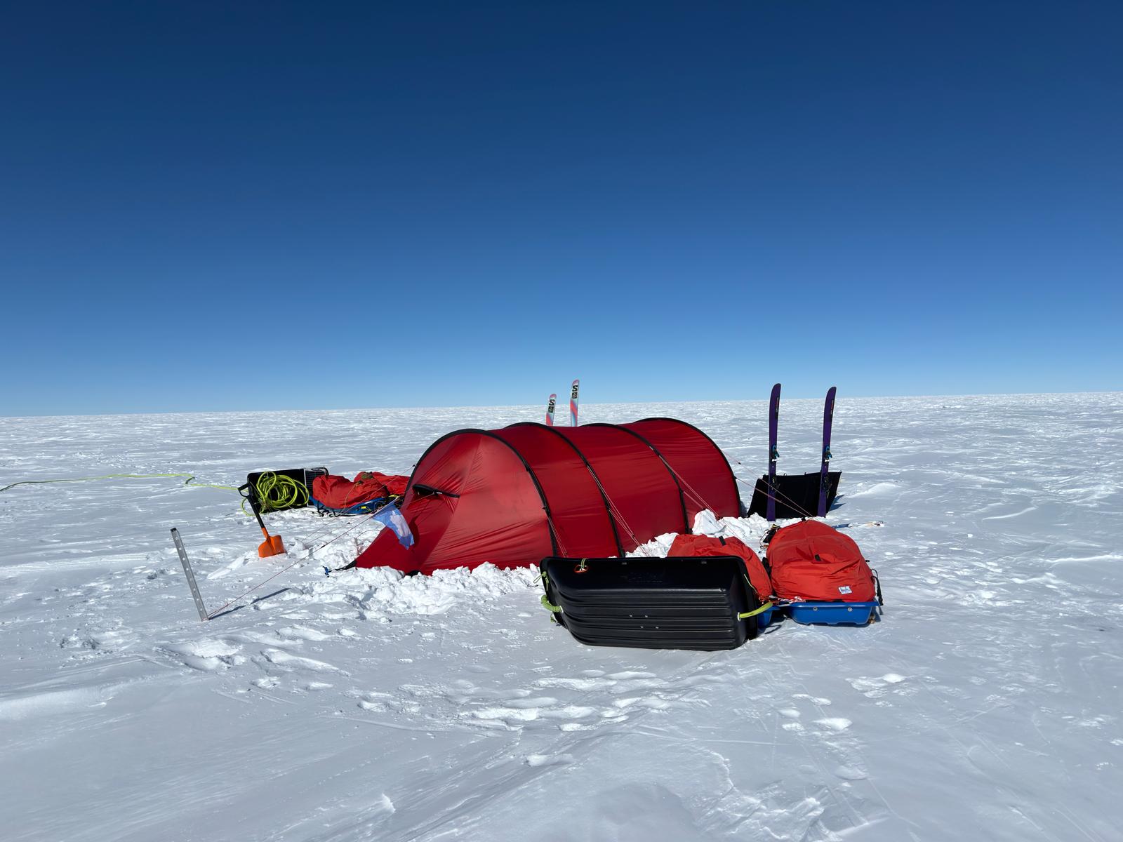 A tent and equipment in the snow