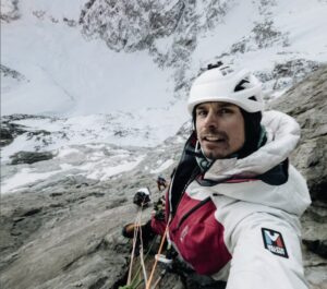 Selfie by Dubouloz at a belay on a huge rock and ice face.