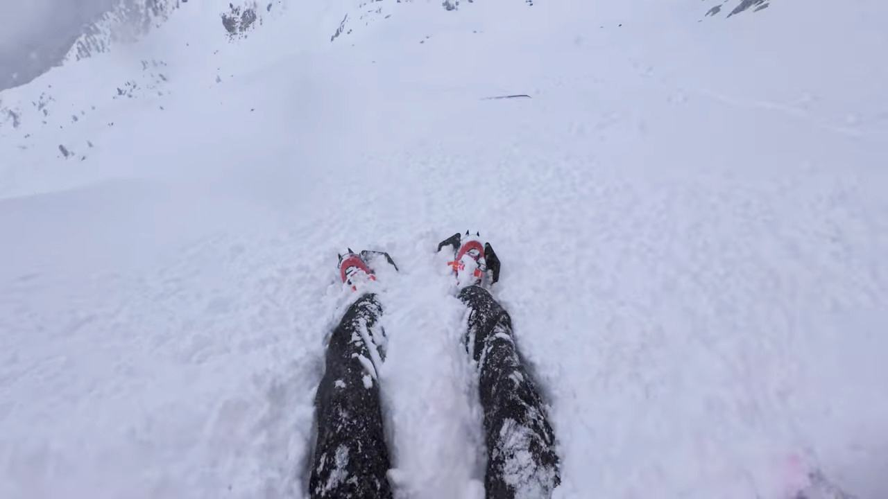 A man being swept away in a wave of loose snow