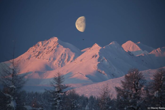 The Chersky Mountains at night with the moon rising above.