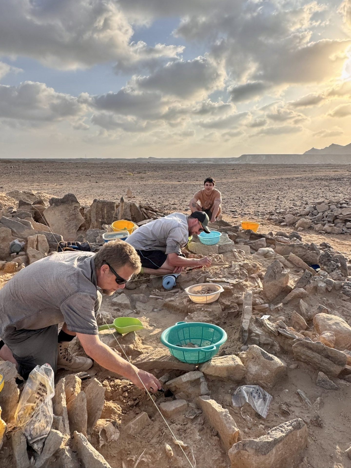 Researchers look for items of interest within the tomb.