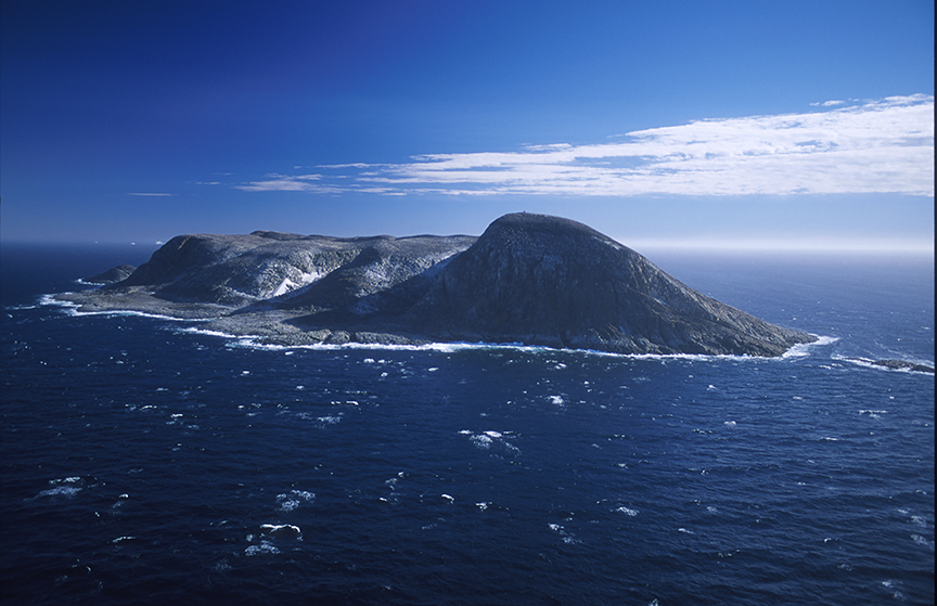rocky island in a choppy ocean