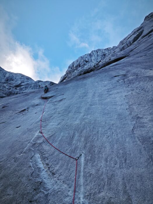 A climber on a smooth granite face.