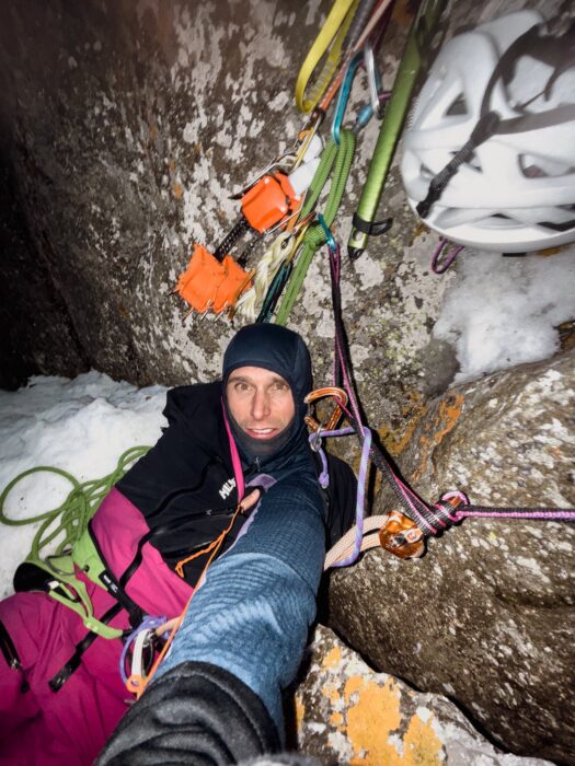 Charles Dubouloz on a wall in the night, no sleeping bag or dawn jacket.