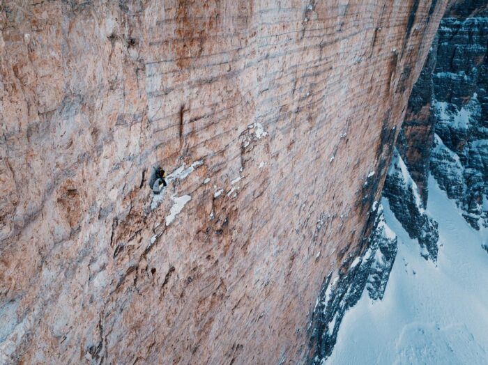 A tiny tent in the middle of a huge dolomitic face.