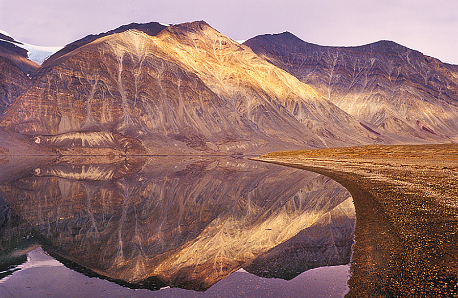 mountains mirrored in calm water