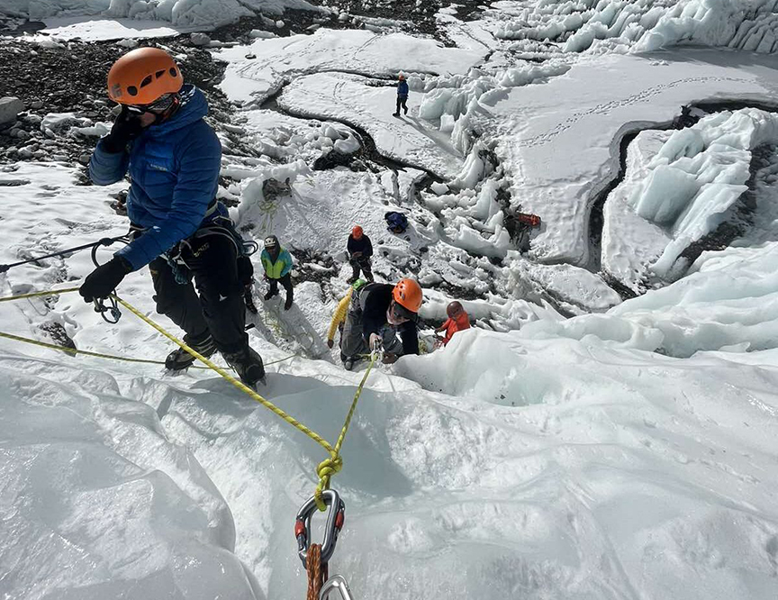 Sherpas fixing ropes on ice at Everest Khumbu Icefall.