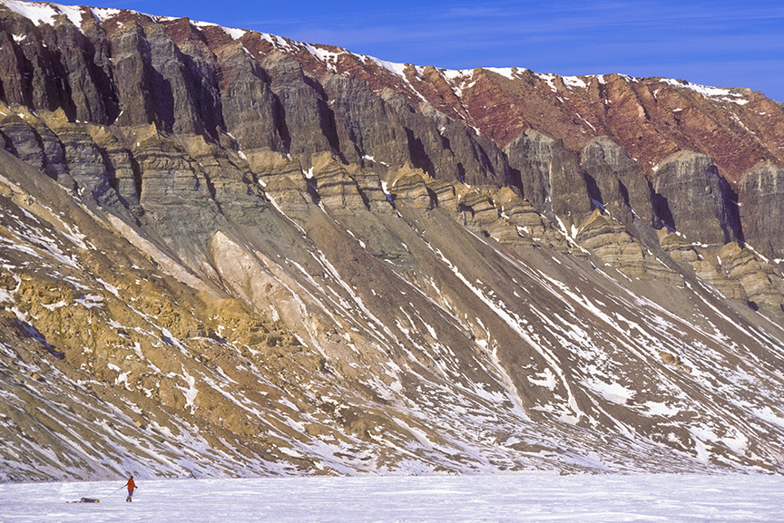 tiny sledder beside cliff
